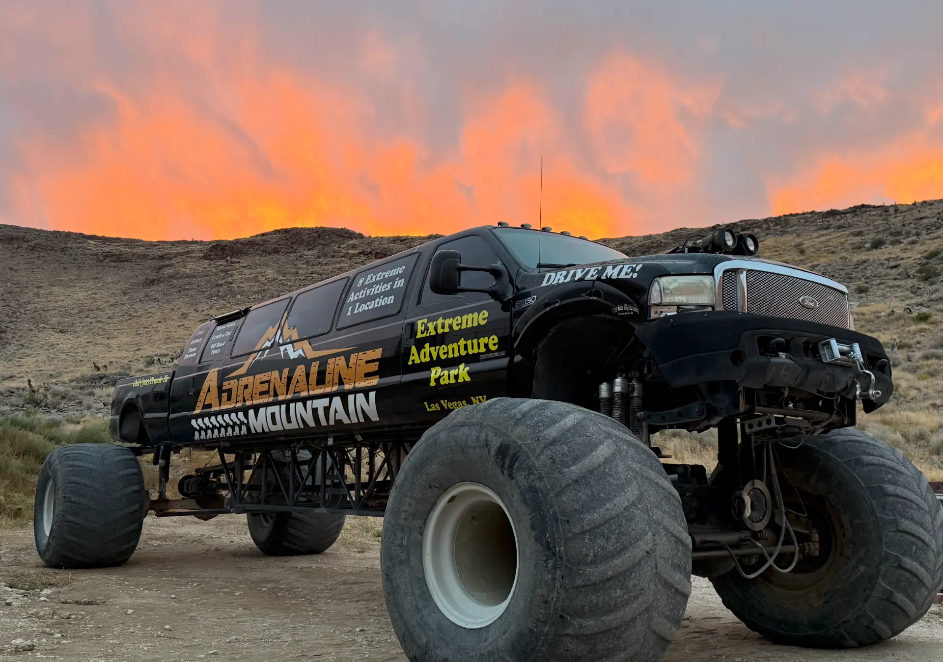 Adrenaline Mountain monster truck parked in the Mojave Desert at sunset