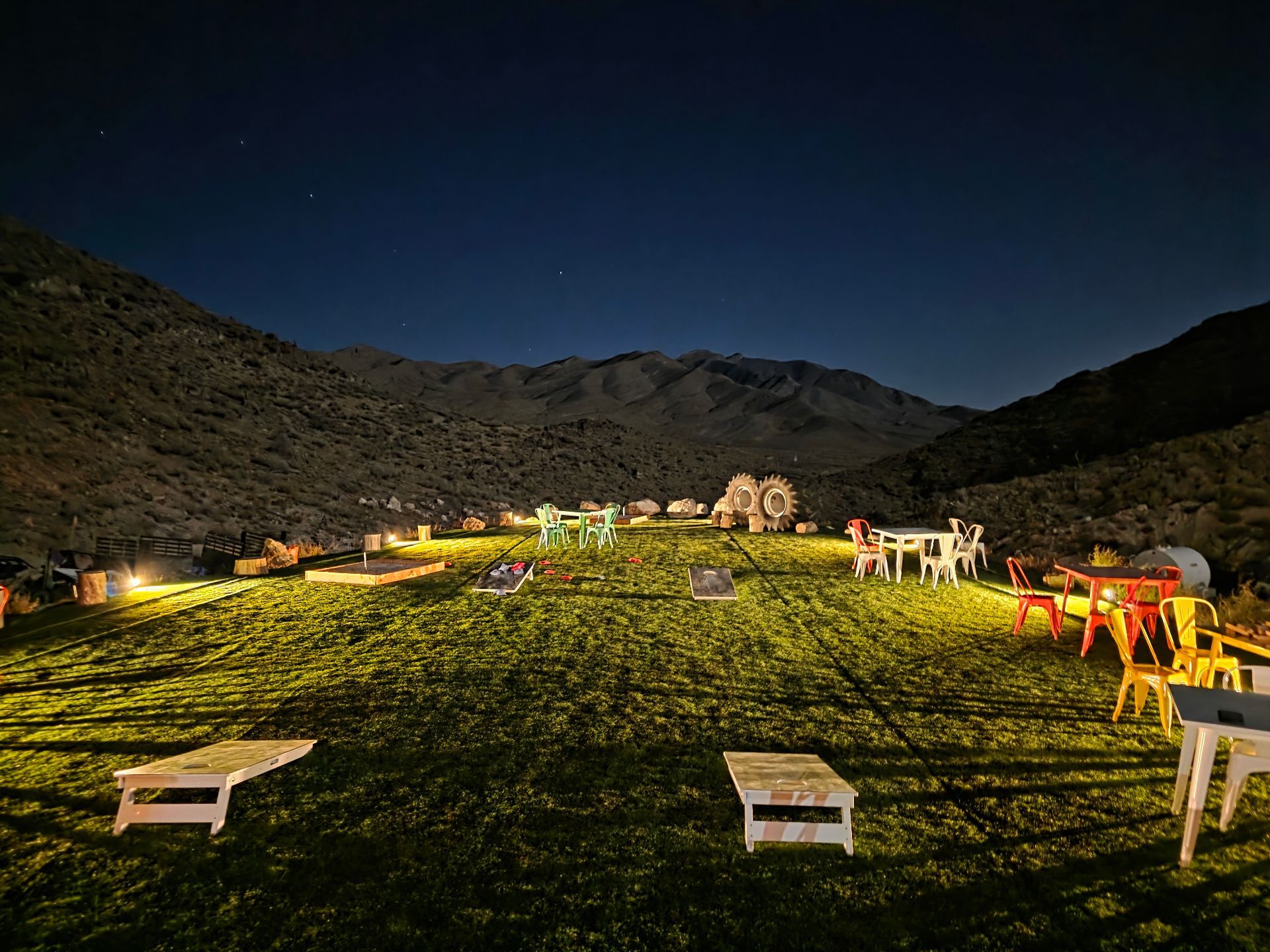 Nighttime outdoor event space with mountain views