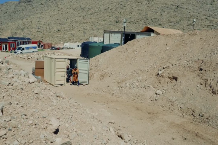 a person sitting on top of a sandy beach