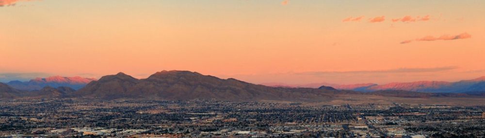 a sunset view with a mountain in the background