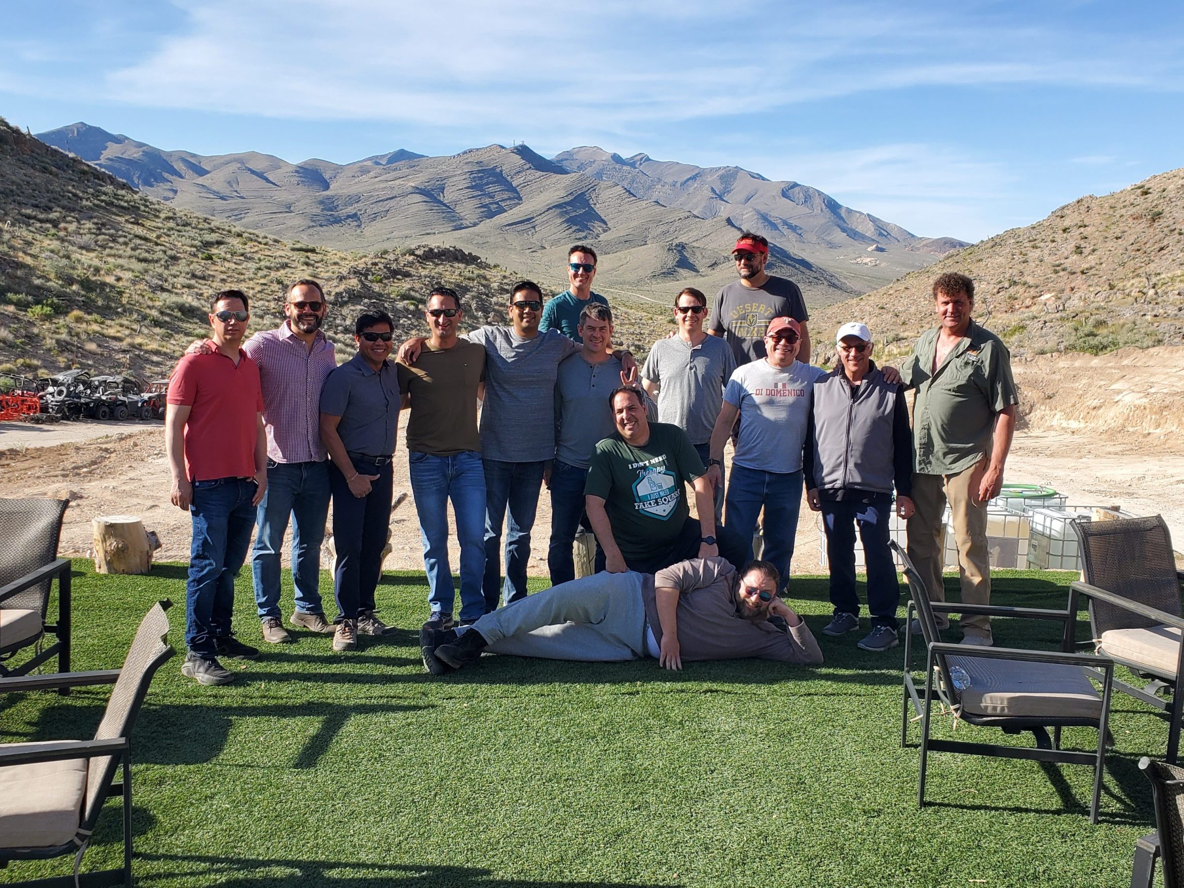 a group of people sitting on a bench in front of a mountain